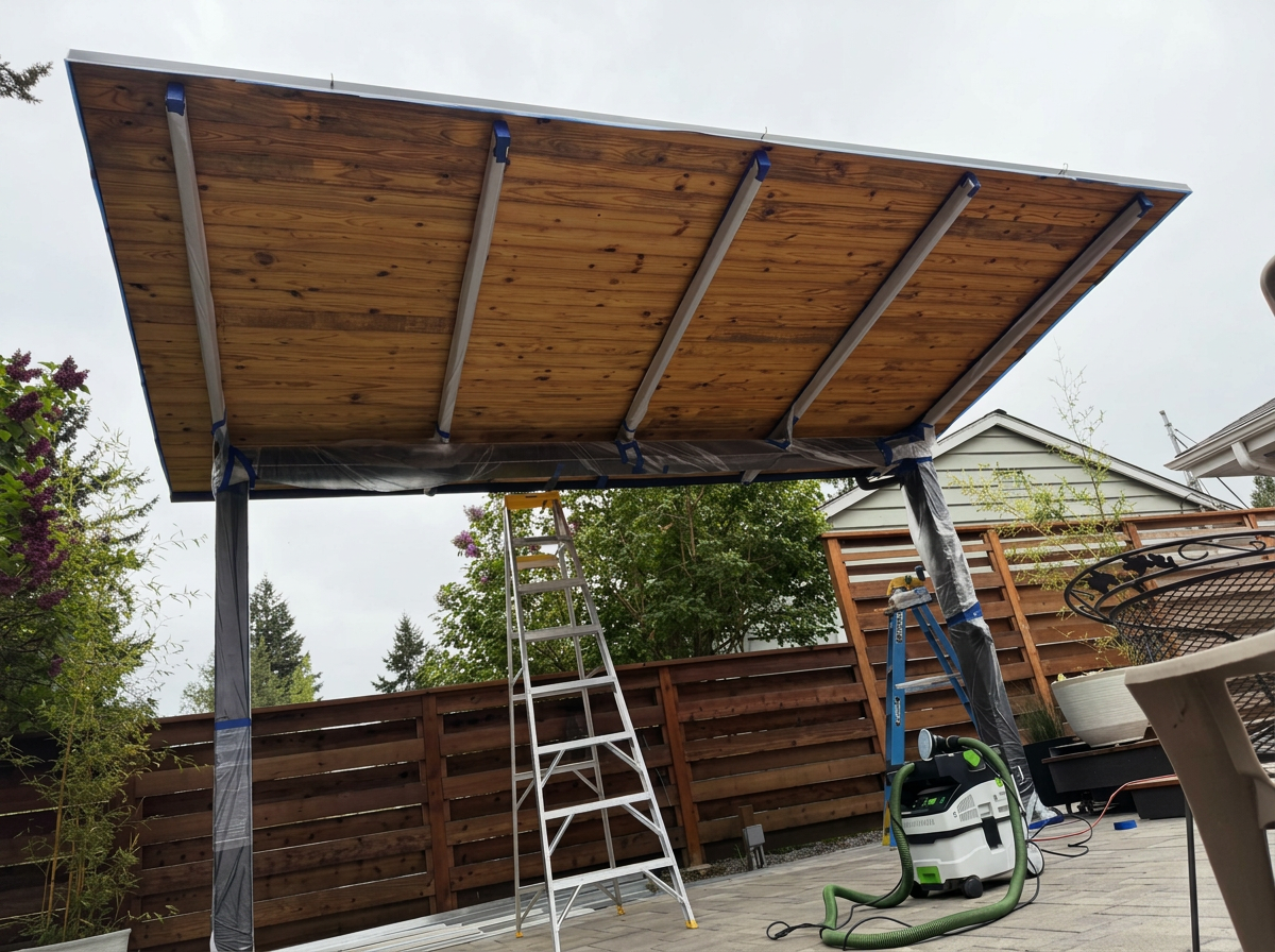 Weathered wooden patio cover before restoration in a Greater Seattle backyard