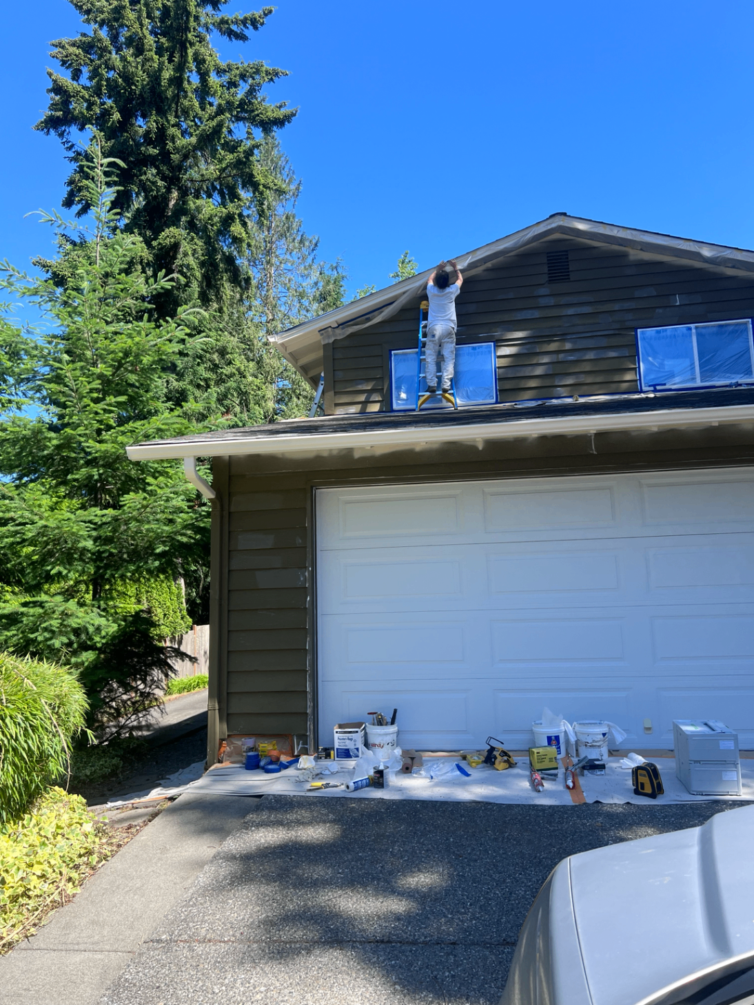 Painter actively working on an exterior repaint project